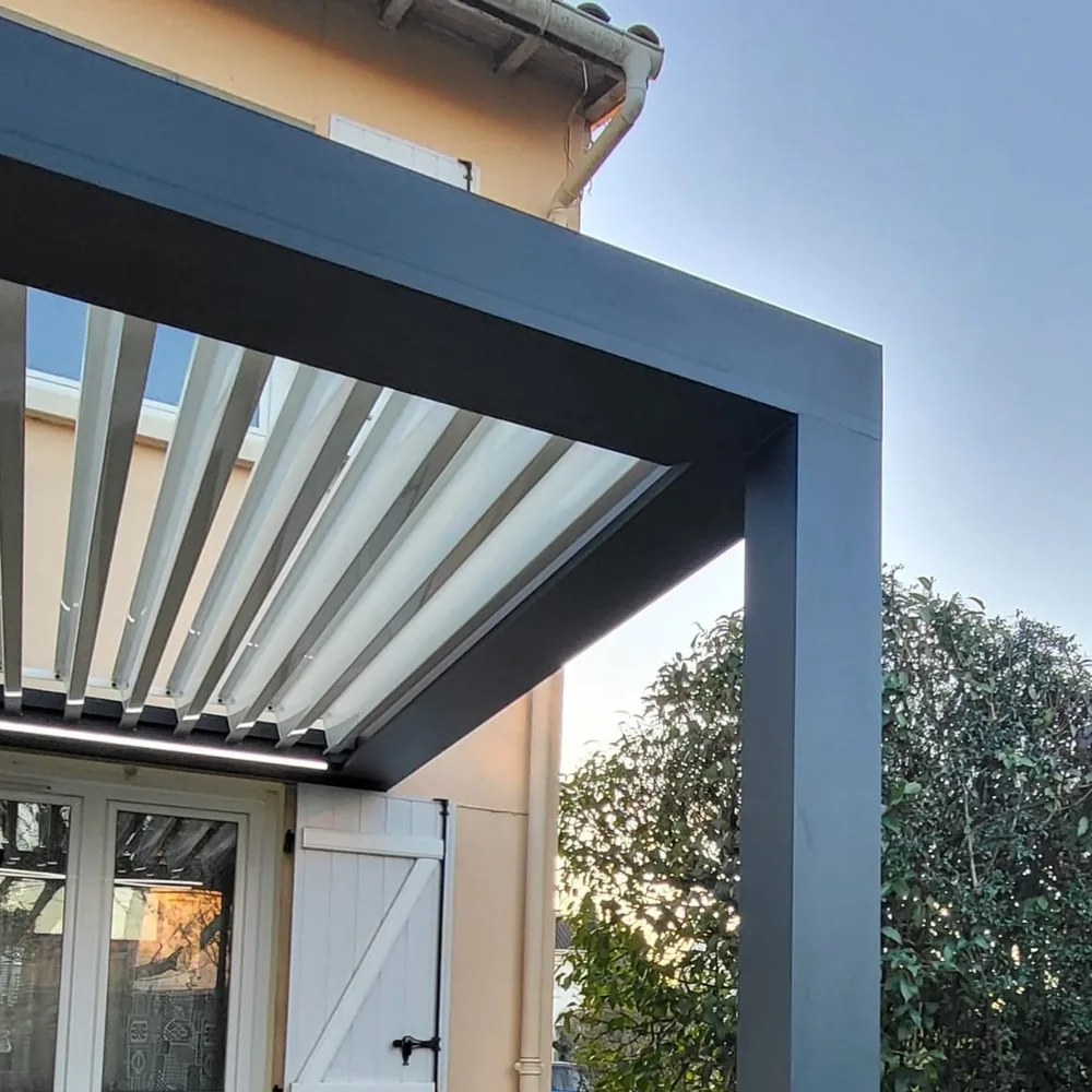 Pergola bioclimatique anthracite installée sur la terrasse d’une maison